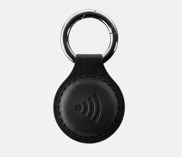 Zaat leather NFC keychain being tapped with a smartphone